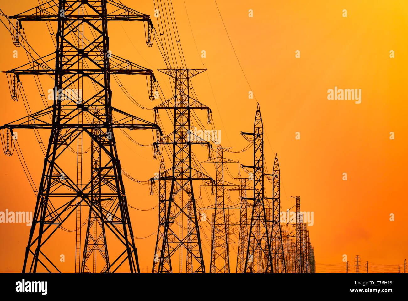 High voltage electric pole and transmission lines in the evening ...