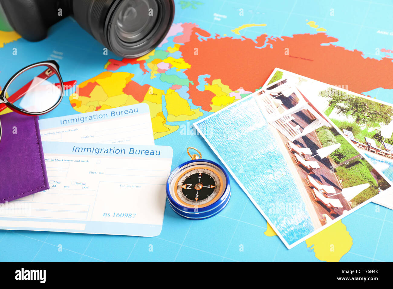 Composition with compass and immigration bureau cards on world map. Travel planning concept Stock Photo