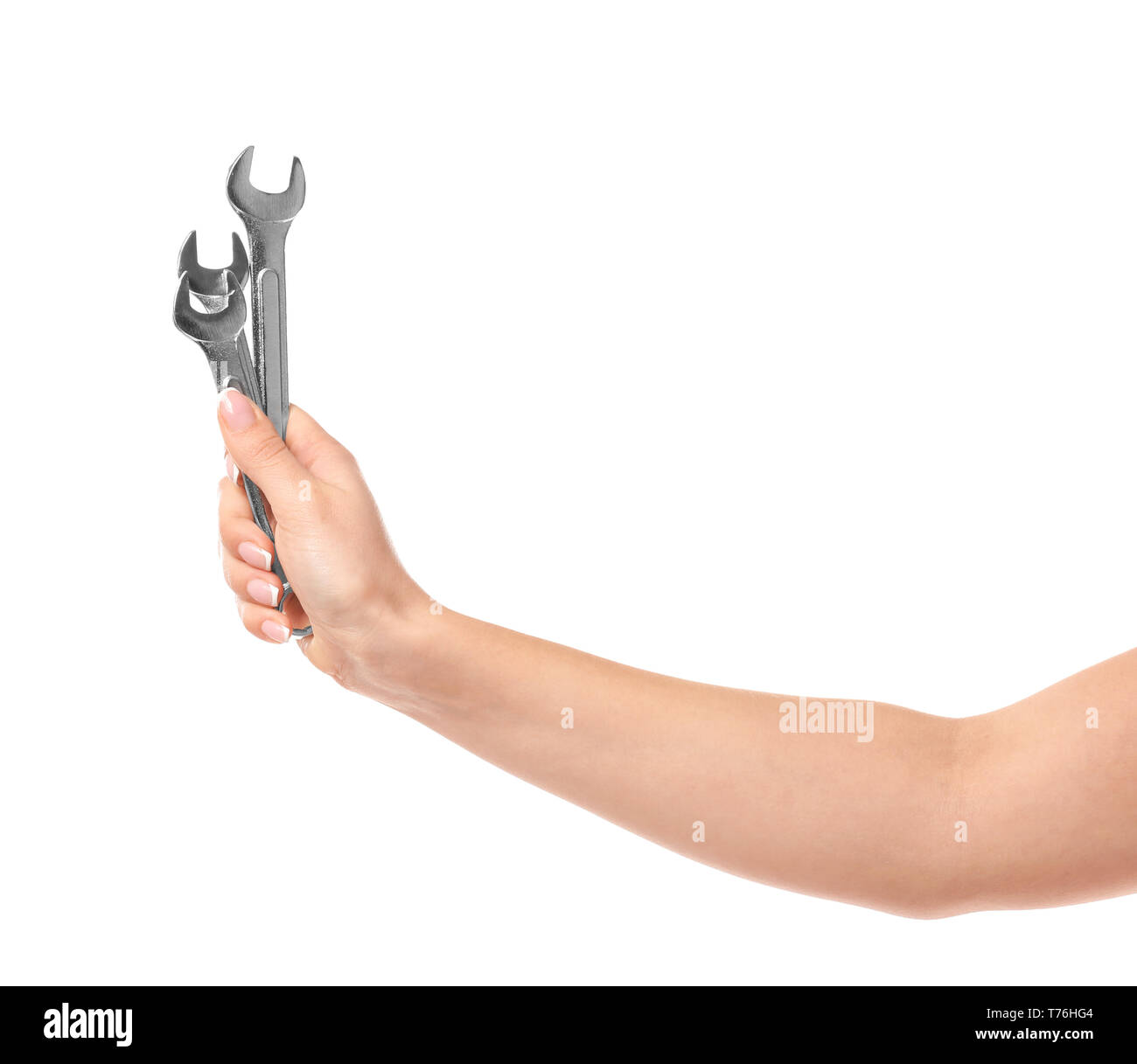 Hand of female car mechanic with wrenches on white background Stock