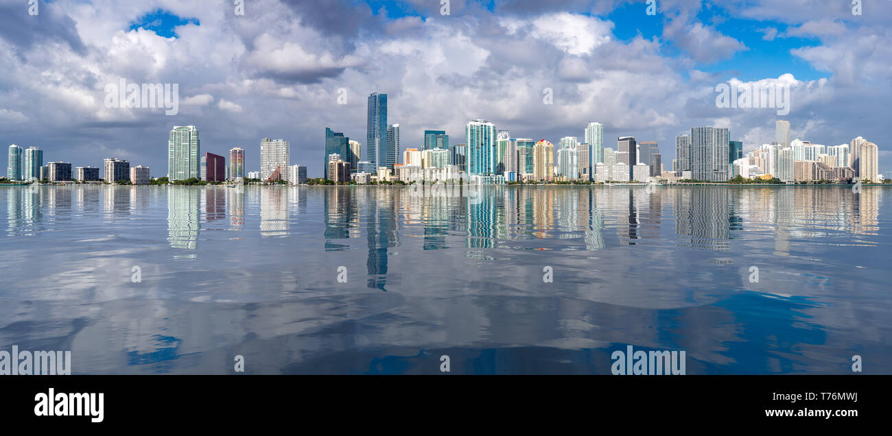 Broad panorama of the city of Miami Skyline with reflection into an artificial water surface Stock Photo