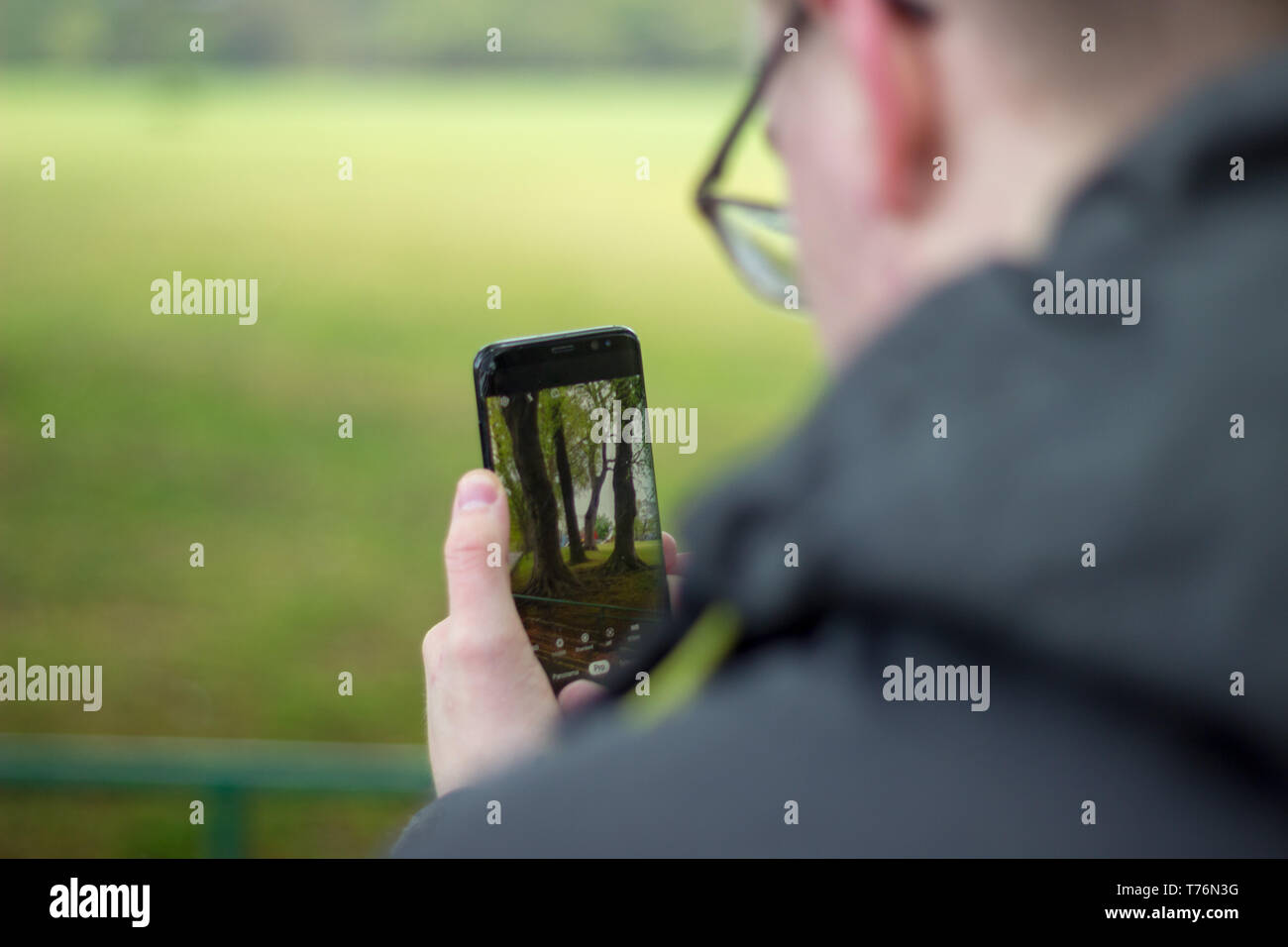 Man taking a picture with his phone Stock Photo