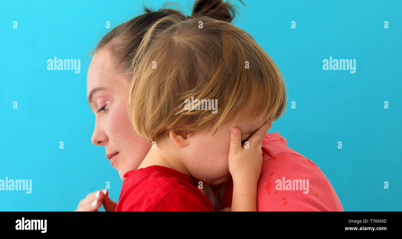 woman soothes crying son Stock Photo