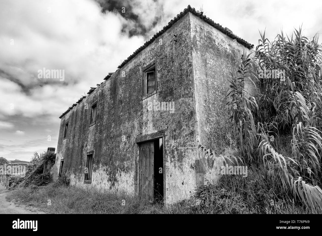 Black and white view of a massive abandoned barn in Ginetes on Sao Miguel island in the Azores. Stock Photo