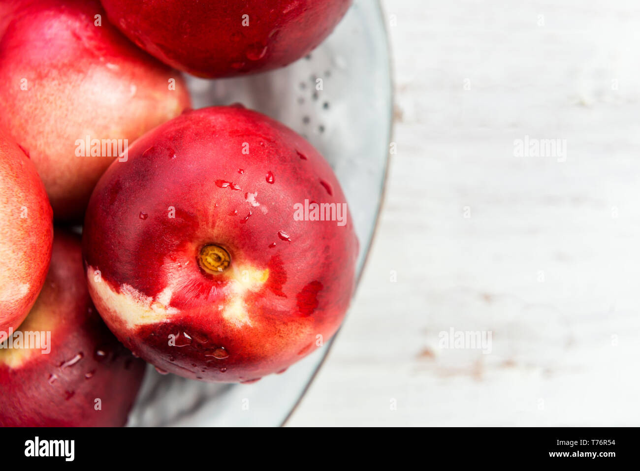 Fresh Nectarines in Rustic Ceramic Plate Stock Photo