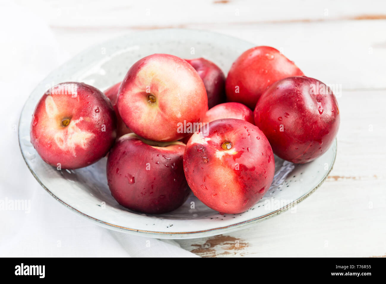 Fresh Nectarines in Rustic Ceramic Plate Stock Photo