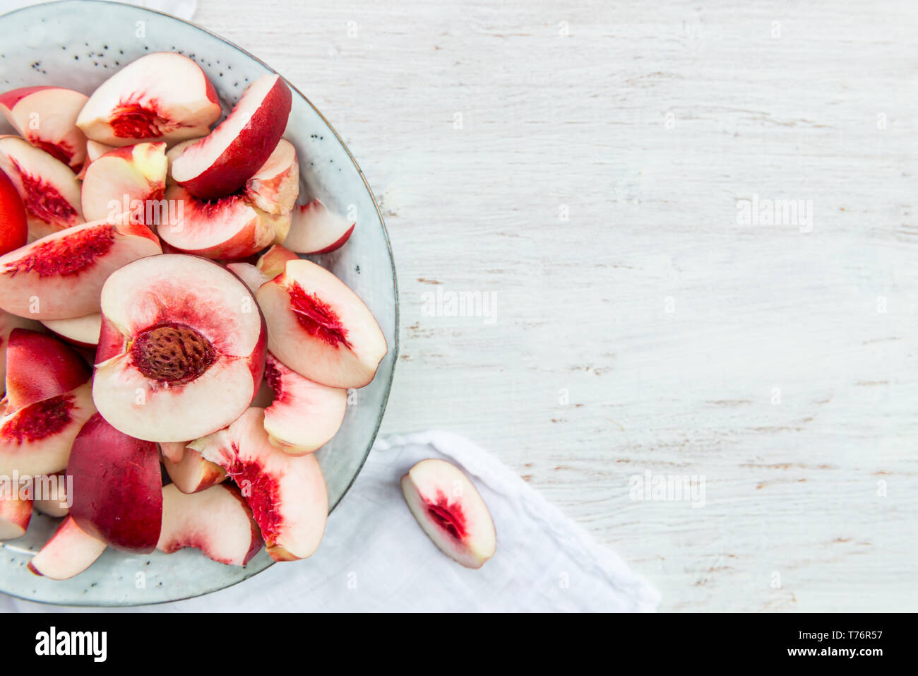 Fresh Nectarines Pieces in Rustic Ceramic Plate Stock Photo