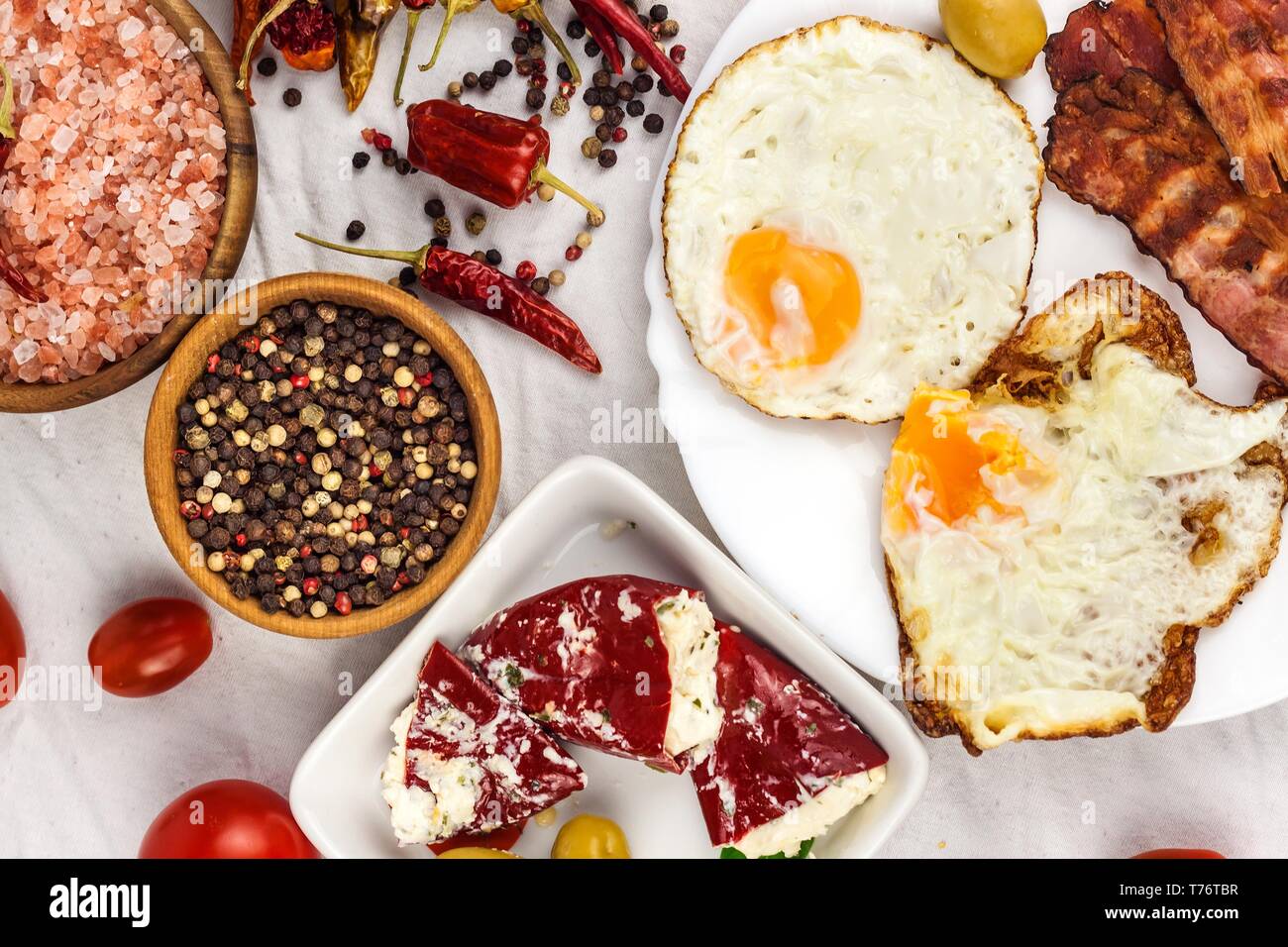 Fried egg and grilled bacon on kitchen table. Healthy breakfast. Protein for athletes Stock