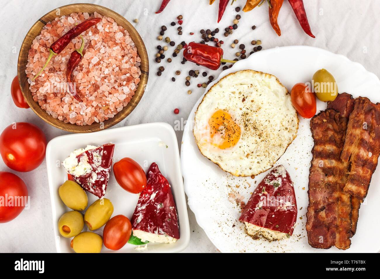 Fried egg and grilled bacon on kitchen table. Healthy breakfast. Protein for athletes Stock