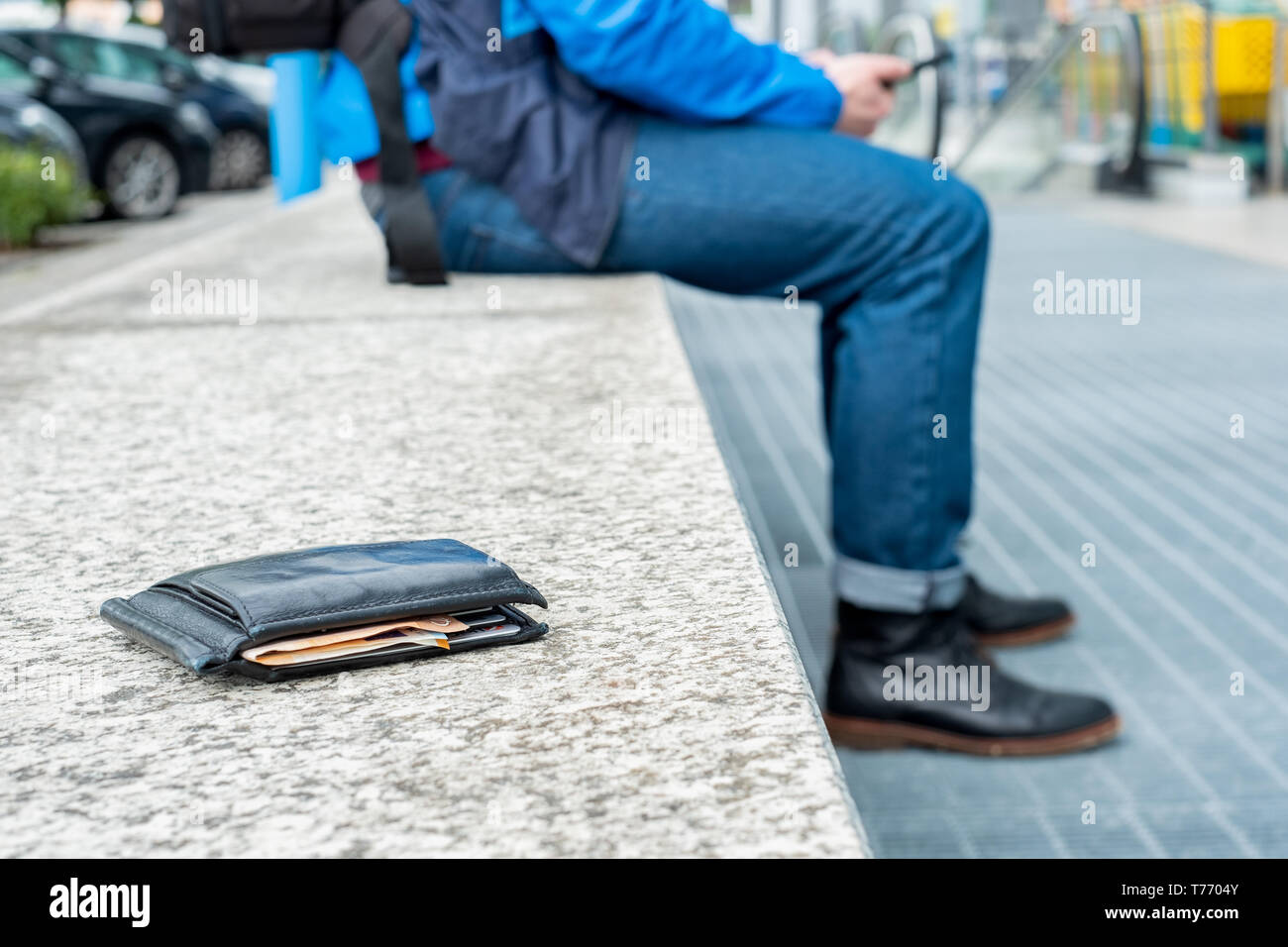Black Wallet With Cash Is Lying Lost On Bench Stock Photo