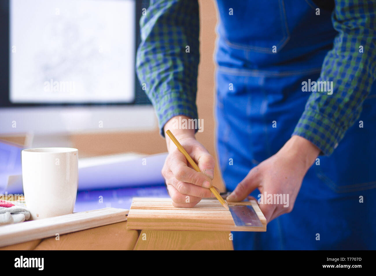 Engineer carpenter working on laptop and sketching project Stock Photo ...