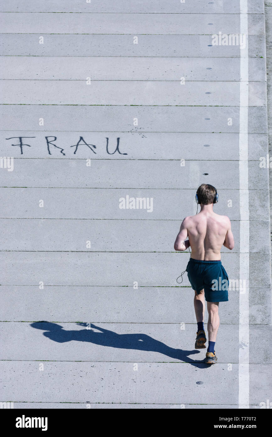 Wien, Vienna: male jogger, man, way at river Wien, shadow, scripture 'Frau' in 14. Penzing, Wien, Austria Stock Photo