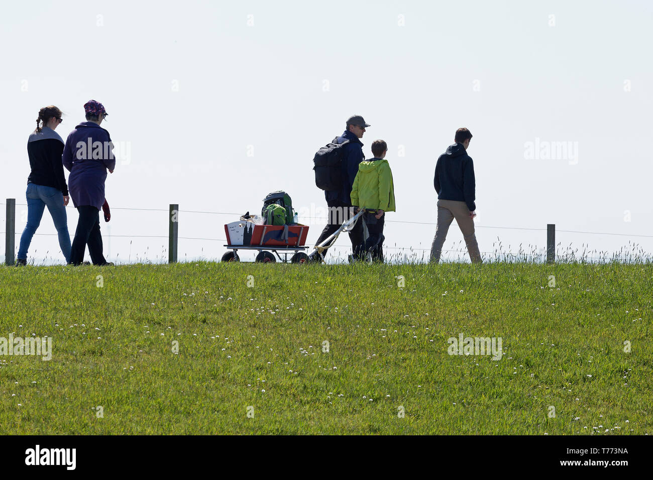 people walking on the dike, Spiekeroog Island, East Friesland, Lower Saxony, Germany Stock Photo