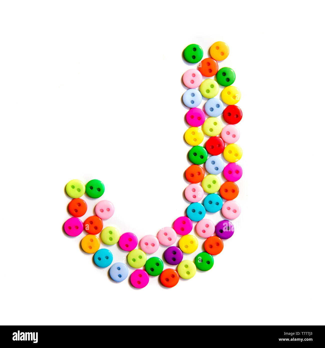 Letter J of the English alphabet from a group of colorful small buttons on a white background Stock Photo