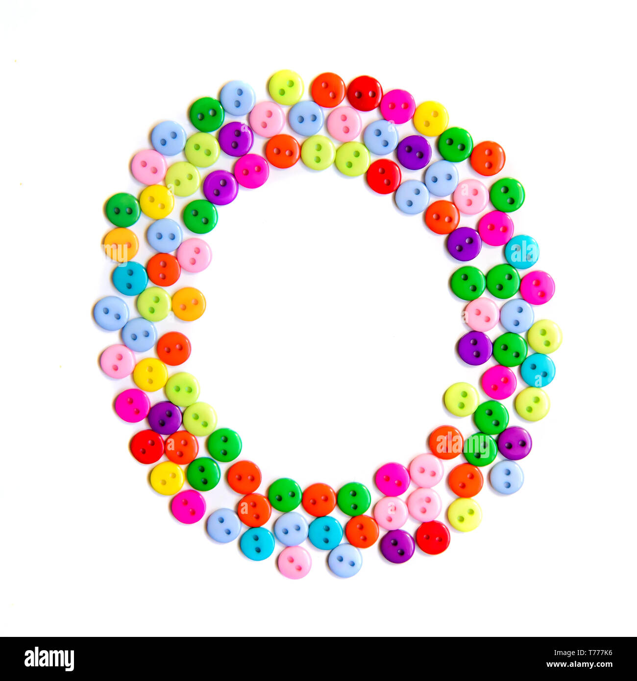 Letter O of the English alphabet from a group of colorful small buttons on a white background Stock Photo