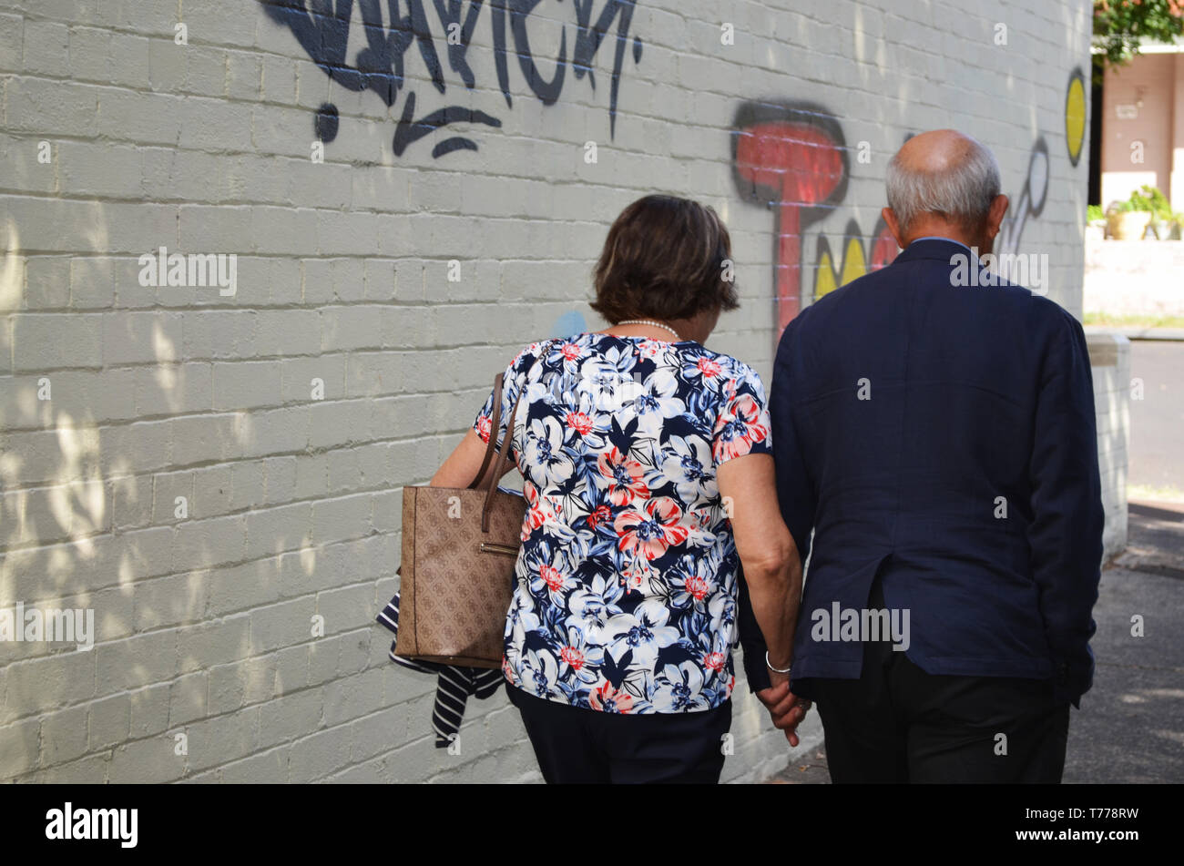 Elderly couple walking in street Stock Photo