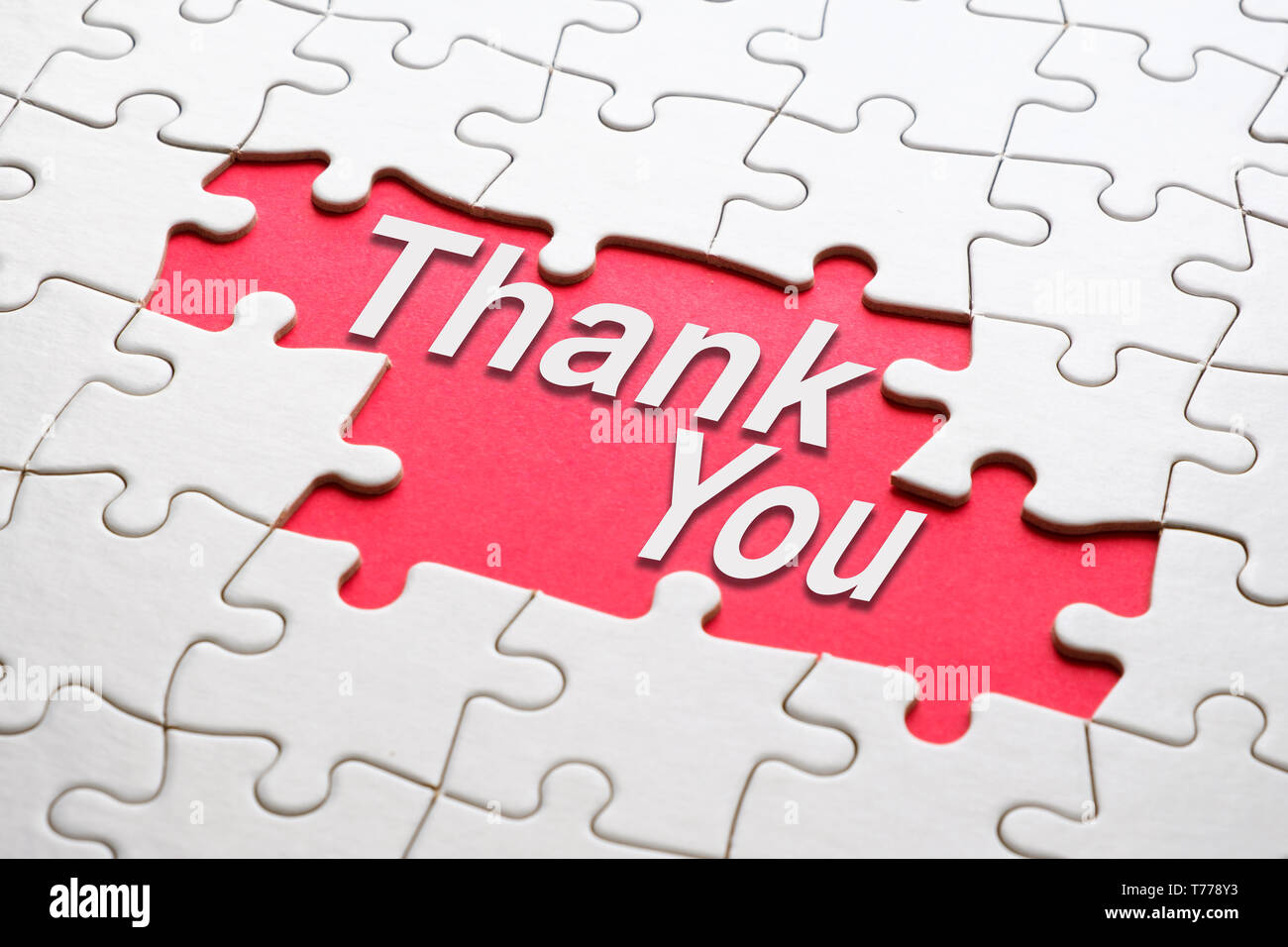 Thank you word reveal under jigsaw puzzle Stock Photo - Alamy
