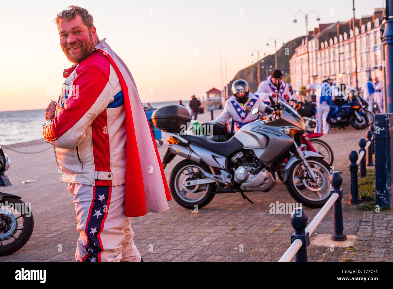 Aberystwyth, Wales. 04th May, 2019.   Some of the 50 motor bikers, all dressed as iconic stunt rider  'Evel Kneivel' arrive in Aberystwyth a dusk  as part of their annual charity fund raising ride around wales.  Now in its 8th year, the bikers start and finish in Wrexham and take 5 days to ride the 1070 mile perimiter of Wales, raising money for Macmillan Cancer Support, ending on Bank Holiday Monday   Credit: keith morris/Alamy Live News Stock Photo