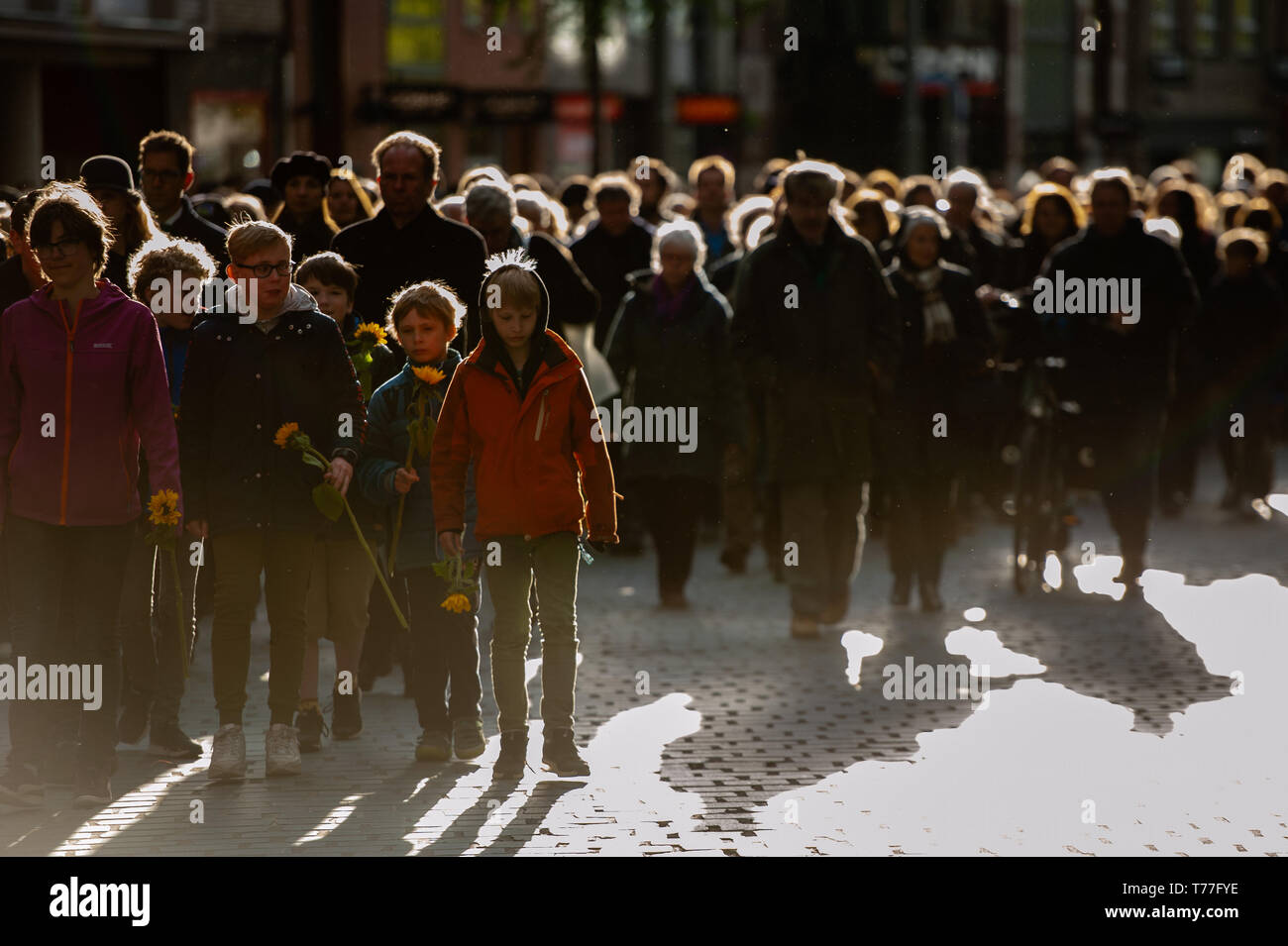 Nijmegen, Netherlands. 04th May, 2019. People with flowers are seen walking in silence to the monument during the event. Remembrance day celebrations of the victims of WWII in Nijmegen was held with several ceremonies, including: unveiling a plaque with an honorary list of the fallen soldiers of WWII on Plein 1944 square, After that, the commemorations took place at the 'Kitty de Wijze', Then from St. Stephen's Church a silent procession on the streets of 'Keizer Traianusplein', where two monuments of the victims of WWII stand. Credit: SOPA Images Limited/Alamy Live News Stock Photo