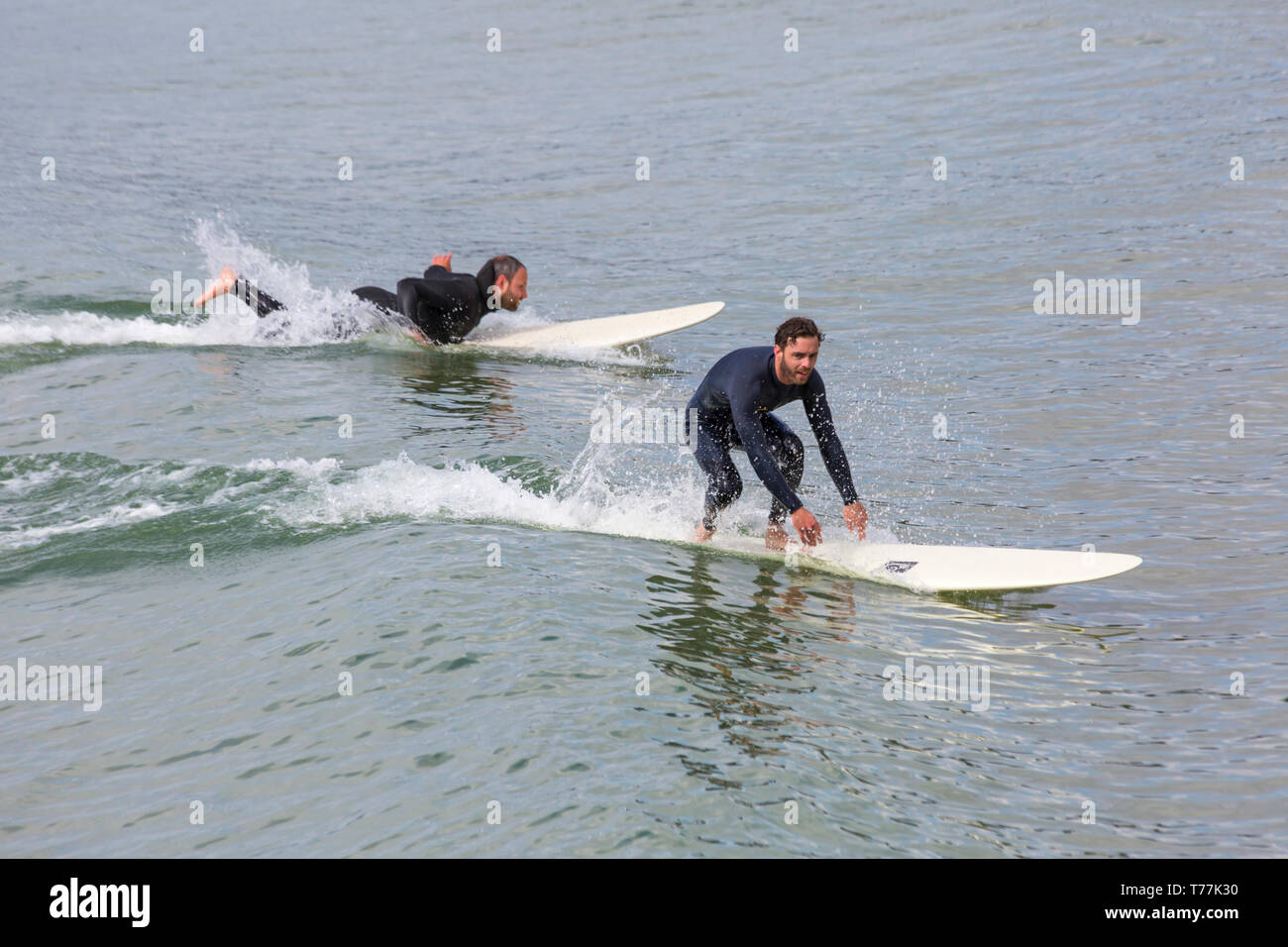 Bournemouth, Dorset, UK. 5th May 2019. UK weather: sunshine, but cool for the morning at Bournemouth beaches and mainly empty in stark contrast to the last Bank Holiday weekend. Surfers in action.   Credit: Carolyn Jenkins/Alamy Live News Stock Photo