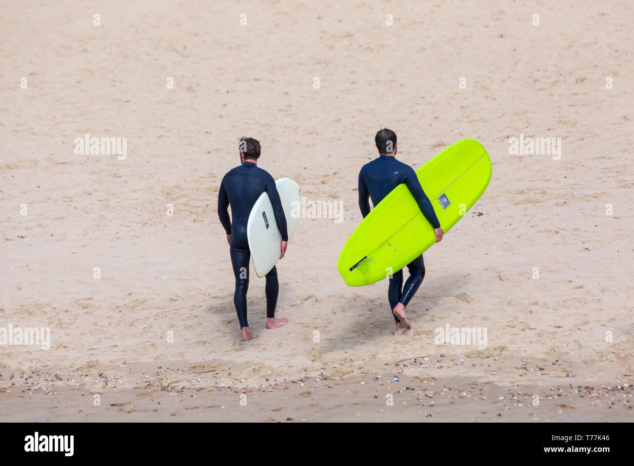 Bournemouth, Dorset, UK. 5th May 2019. UK weather: sunshine, but cool for the morning at Bournemouth beaches and mainly empty in stark contrast to the last Bank Holiday weekend.  Surfers on the beach.  Credit: Carolyn Jenkins/Alamy Live News Stock Photo