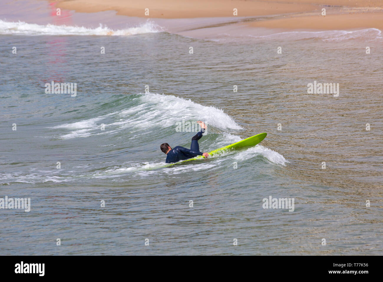 Bournemouth, Dorset, UK. 5th May 2019. UK weather: sunshine, but cool for the morning at Bournemouth beaches and mainly empty in stark contrast to the last Bank Holiday weekend.  Surfer in action.  Credit: Carolyn Jenkins/Alamy Live News Stock Photo