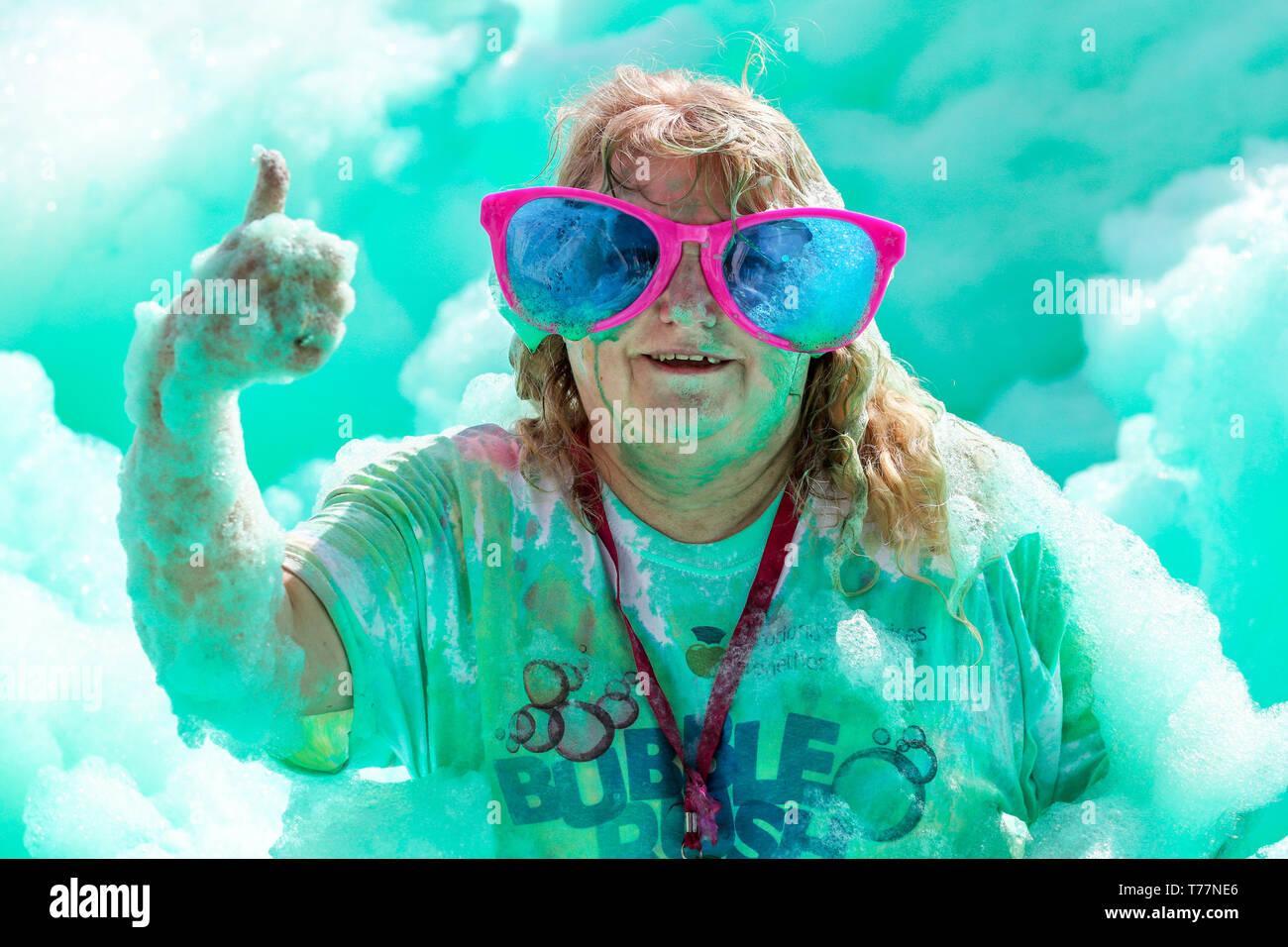 Glasgow, Scotland, UK. 5th May 2019. About 3,500 runners of all ages took part in the Bubble Rush Charity Run through Bellahouston Park, Glasgow to raise funds for the 'Prince and Princess of Wales Hospice'. The runners had to race over 5 kilometres and through pits of blue, yellow, red and green coloured foam before they successfully crossed the finish line. Credit: Findlay/Alamy Live News Stock Photo