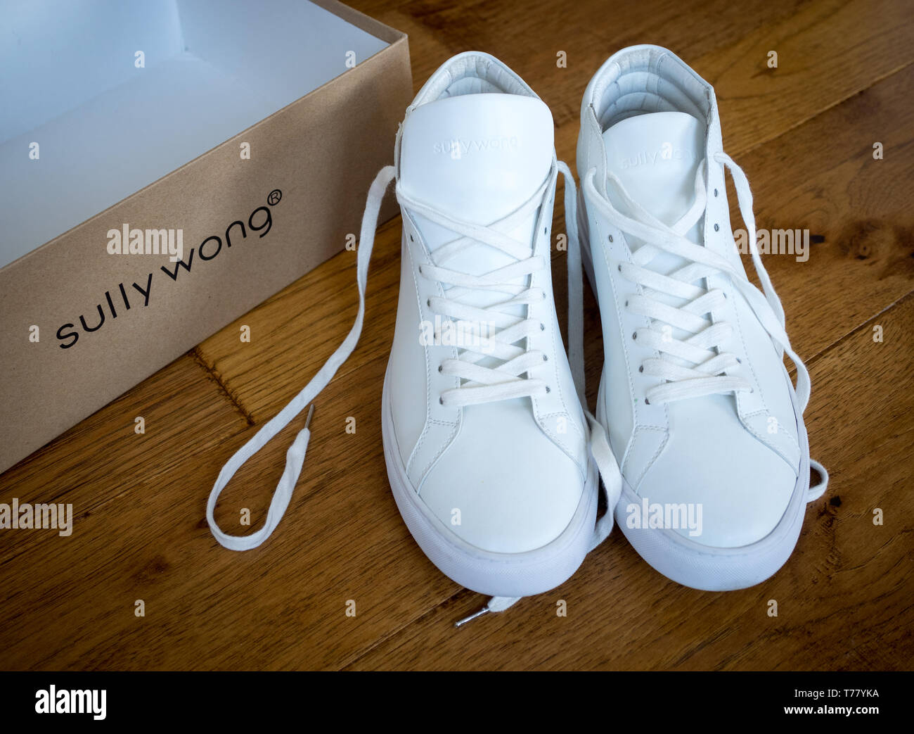 A pair of white high top sneakers from Sully Wong, an indie Canadian shoe brand. Stock Photo