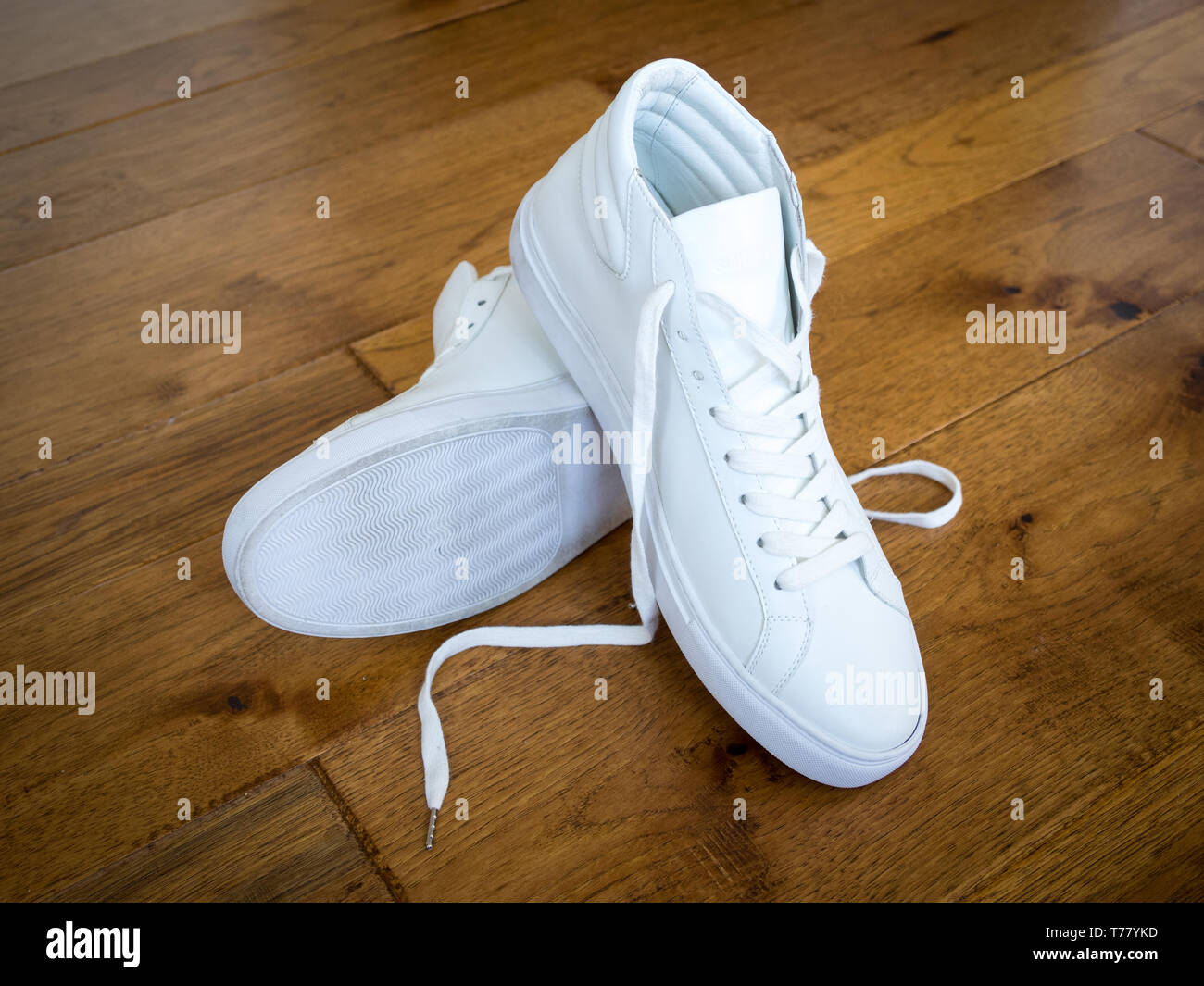 A pair of white high top sneakers from Sully Wong, an indie Canadian shoe brand. Stock Photo