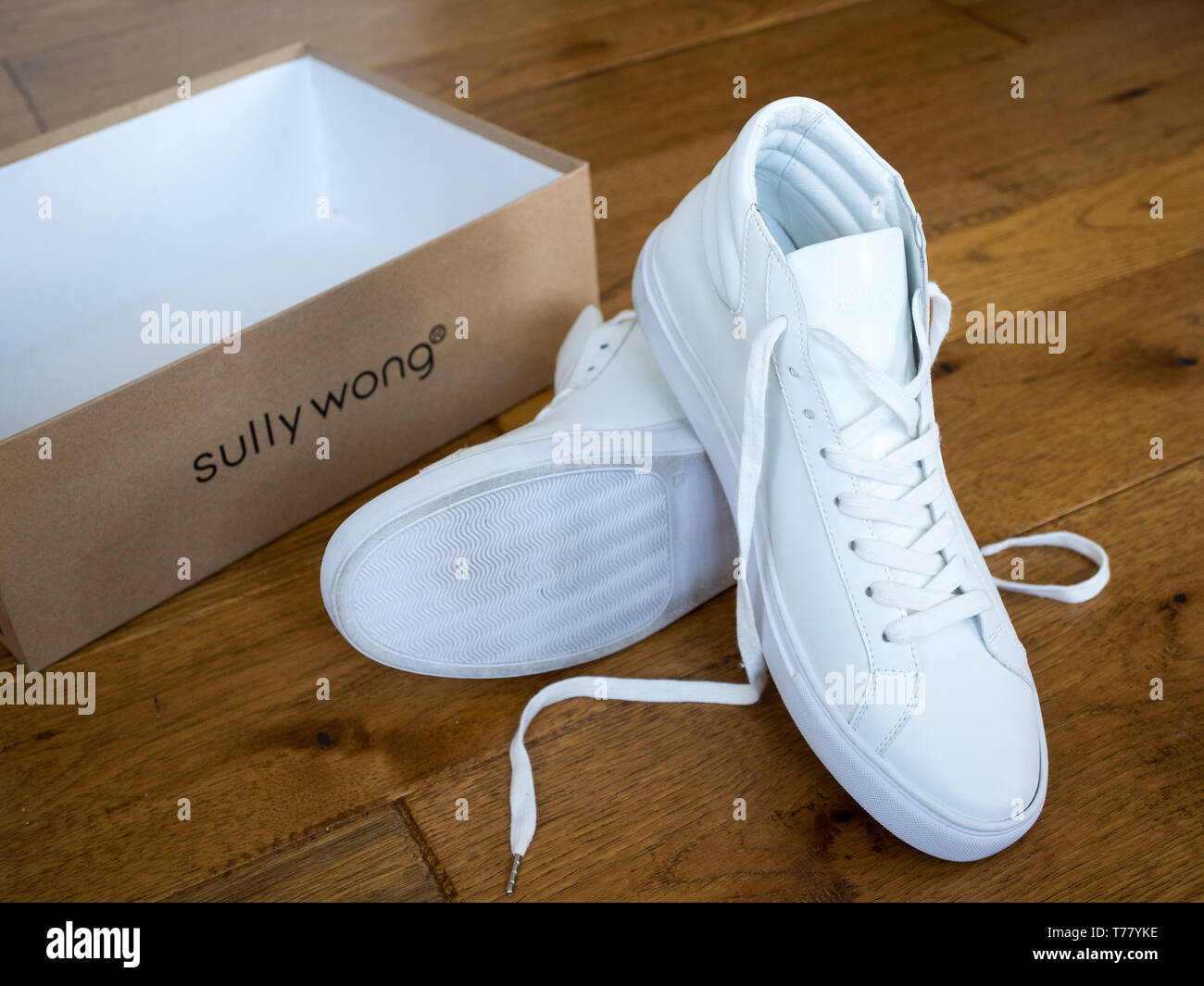 A pair of white high top sneakers from Sully Wong, an indie Canadian shoe brand. Stock Photo