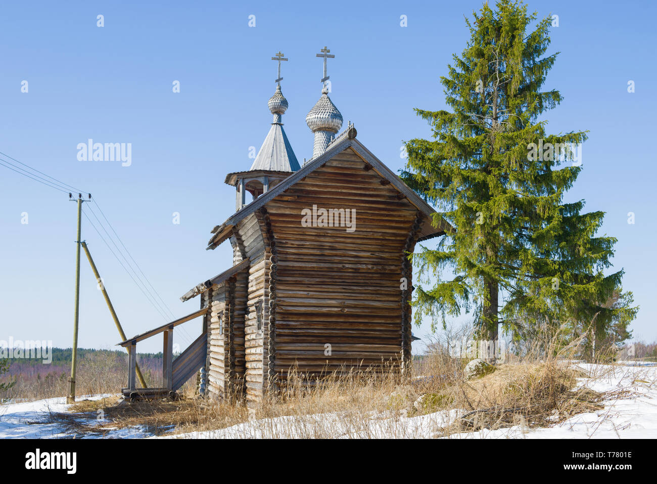 Wooden chapel of the Nativity of the Virgin on a sunny April day. The village of Manga, Karelia. Russia Stock Photo