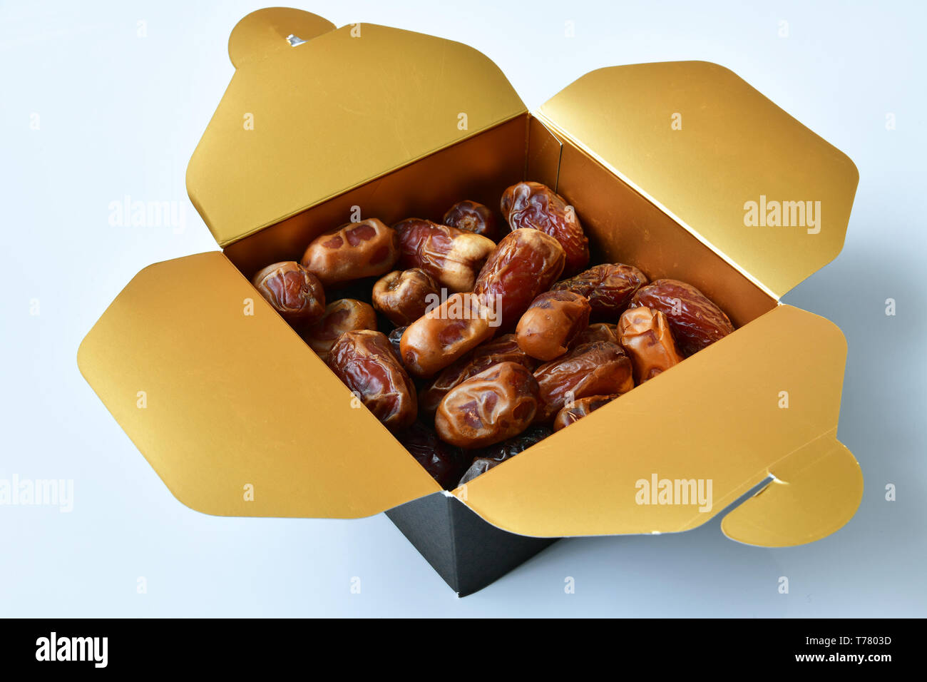 Dried dates in a box on white background Stock Photo Alamy