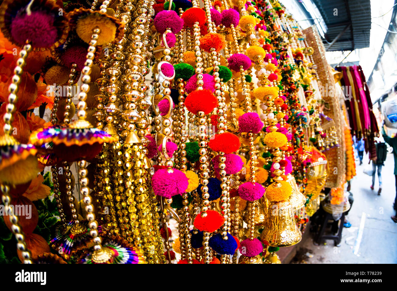 Dangling golden decorations with bells and puffs hanging in a store in