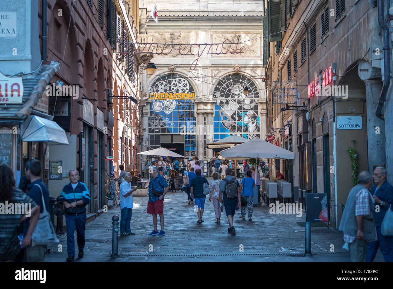 Genoa, Genova, Italy: Tourists and locals walking around piazza Banchi and Loggia della Mercanzia in the old town, with traditional bar dehors Stock Photo