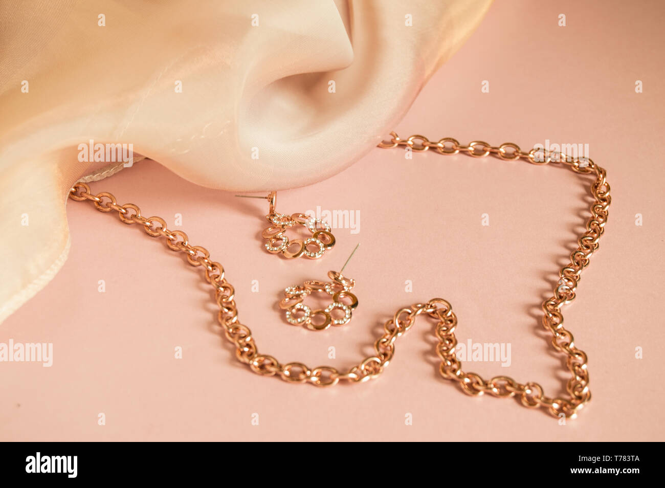 luxury gold jewelry chain and earrings on pink background with silk copy space selective focus stock photo alamy https www alamy com luxury gold jewelry chain and earrings on pink background with silk copy space selective focus image245426394 html