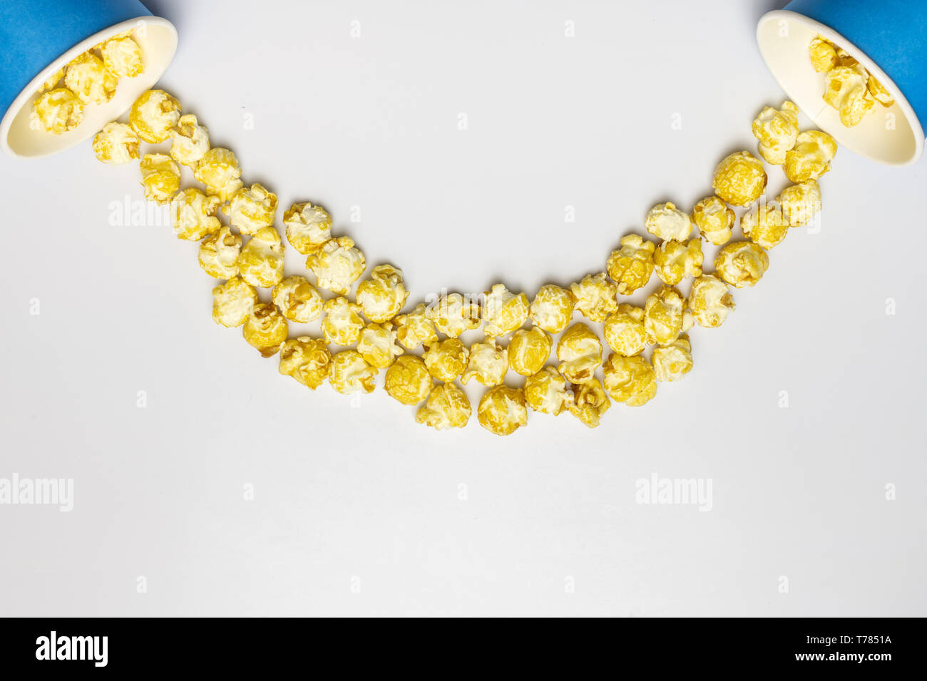 Popcorn concept, cope space. Isolated white background. Delicious sweet popcorn for watching new movies in cinema. Stock Photo