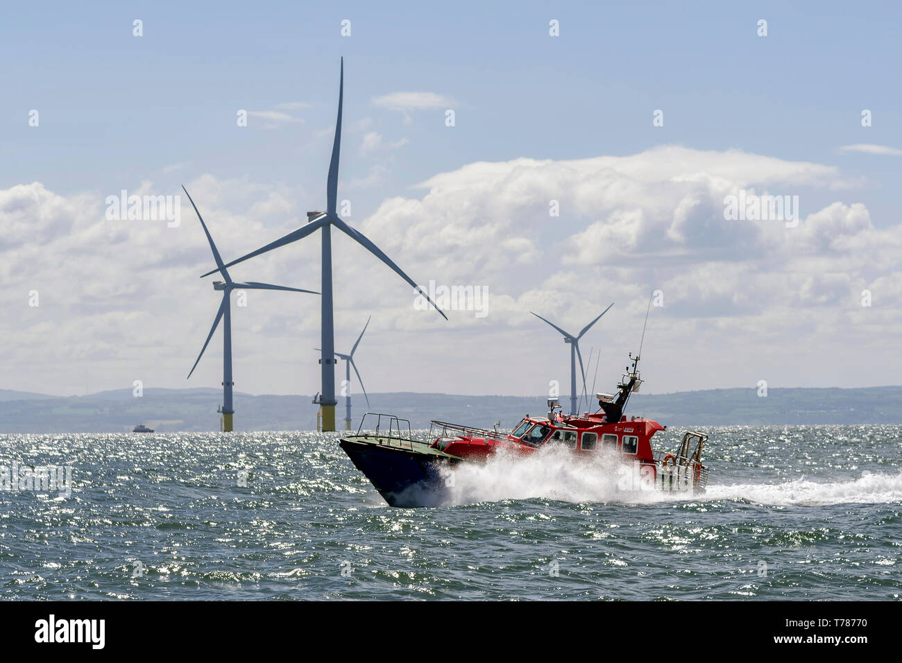 Liverpool pilot launch. River Mersey windfarm windmills. Stock Photo