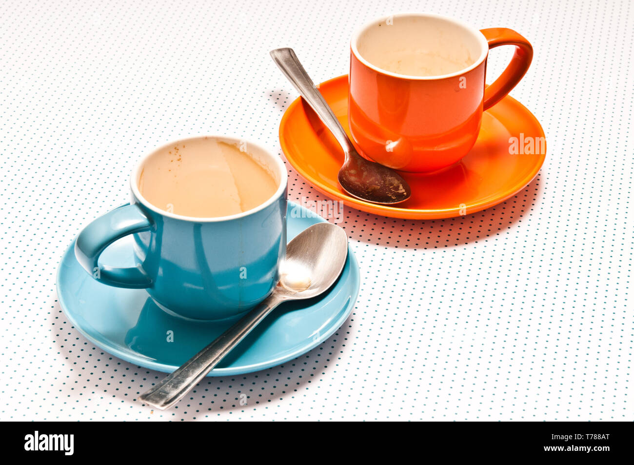 https://c8.alamy.com/comp/T788AT/orange-and-blue-coffee-cups-empty-after-drinking-an-espresso-T788AT.jpg
