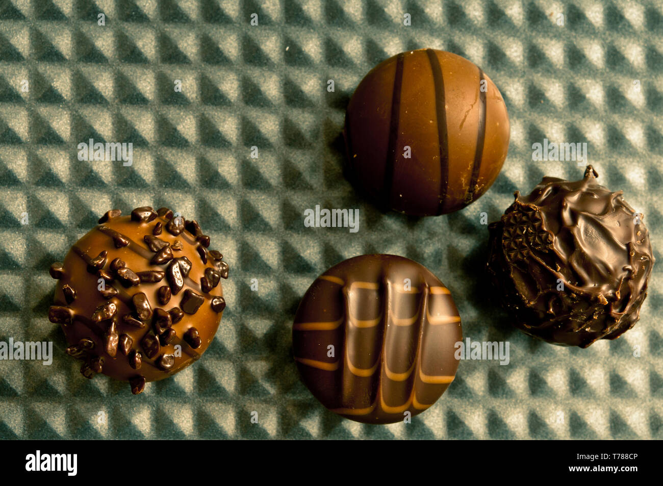 Belgian chocolate bonbons or pralines on a metal surface Stock Photo