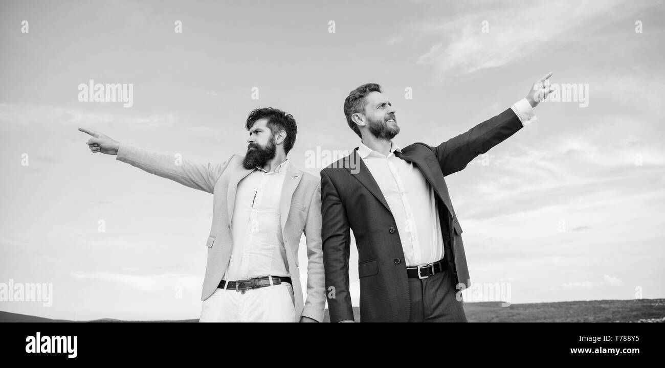 Changing course. Men formal suit managers pointing at opposite