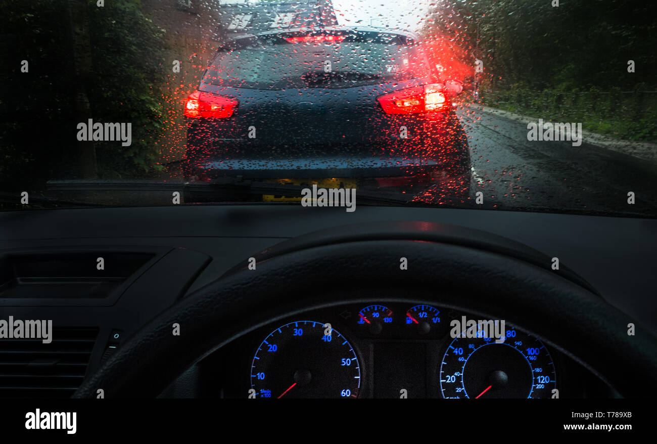 Moody dark image of driving in stormy, wet conditions from the dashboard of a car. Stock Photo