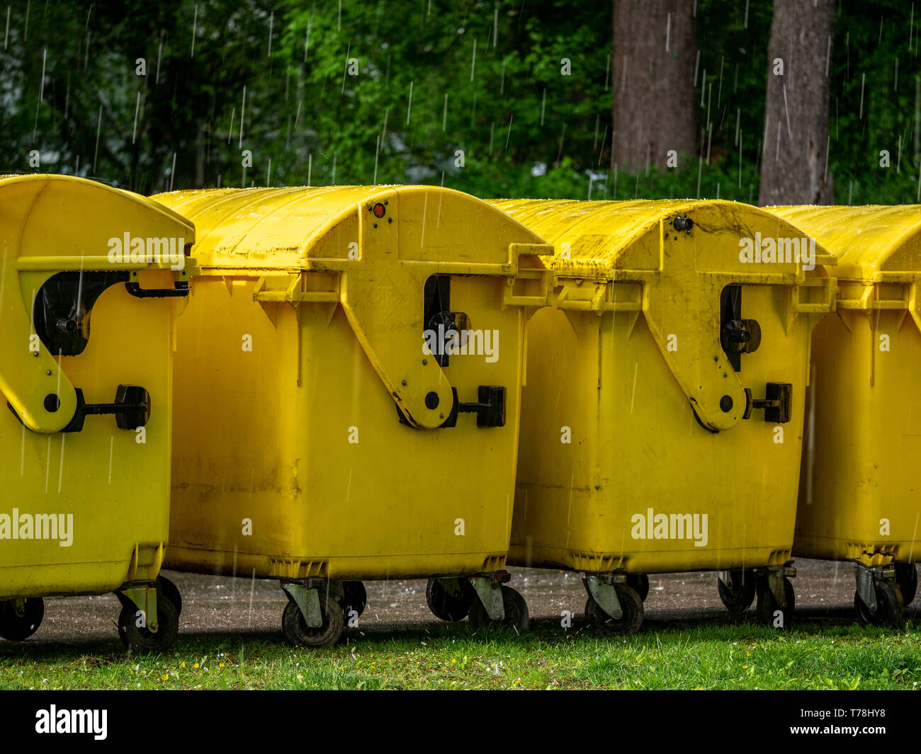 Image of Yellow waste Containers, Recycling bin for special Rubbish, during hail and rainy