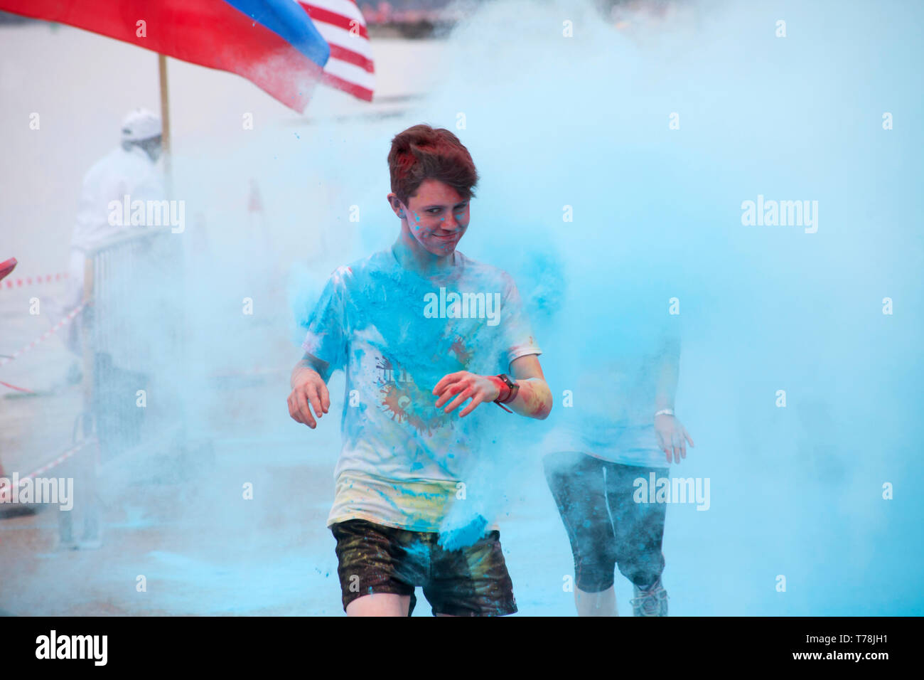 Young man participating in the Helensburgh Colour Canter for charity, Argyll, Scotland, colvered in colourful, blue paint Stock Photo