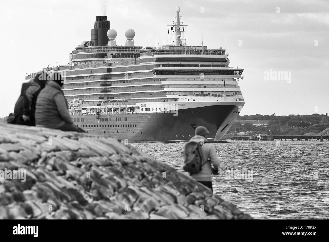 Spectators Watch The Majestic, Cunard Line, MS QUEEN VICTORIA, From Calshot Spit, As She Sails Out Of Southampton For Hamburg. 28 April 2019. Stock Photo