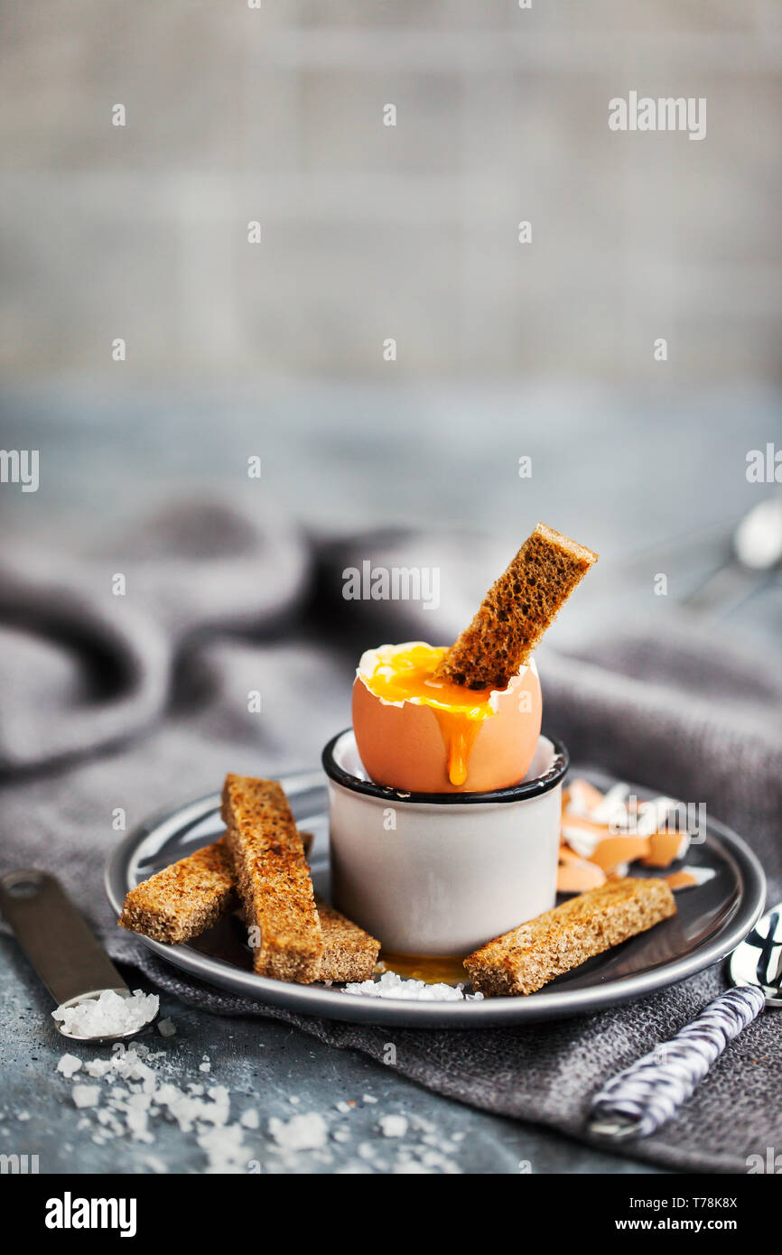 Soft boiled egg with rye toasts for breakfast Stock Photo