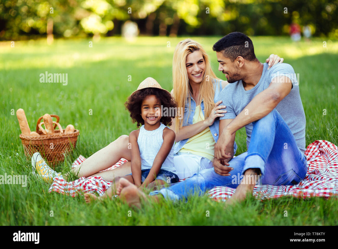 Picture of lovely couple with their daughter having picnic Stock Photo