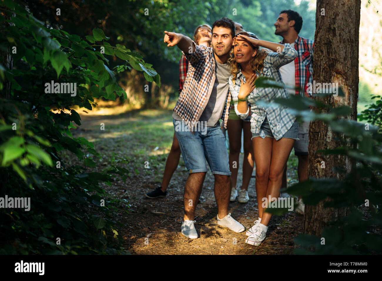 Beautiful woman and friends hiking in forest Stock Photo - Alamy
