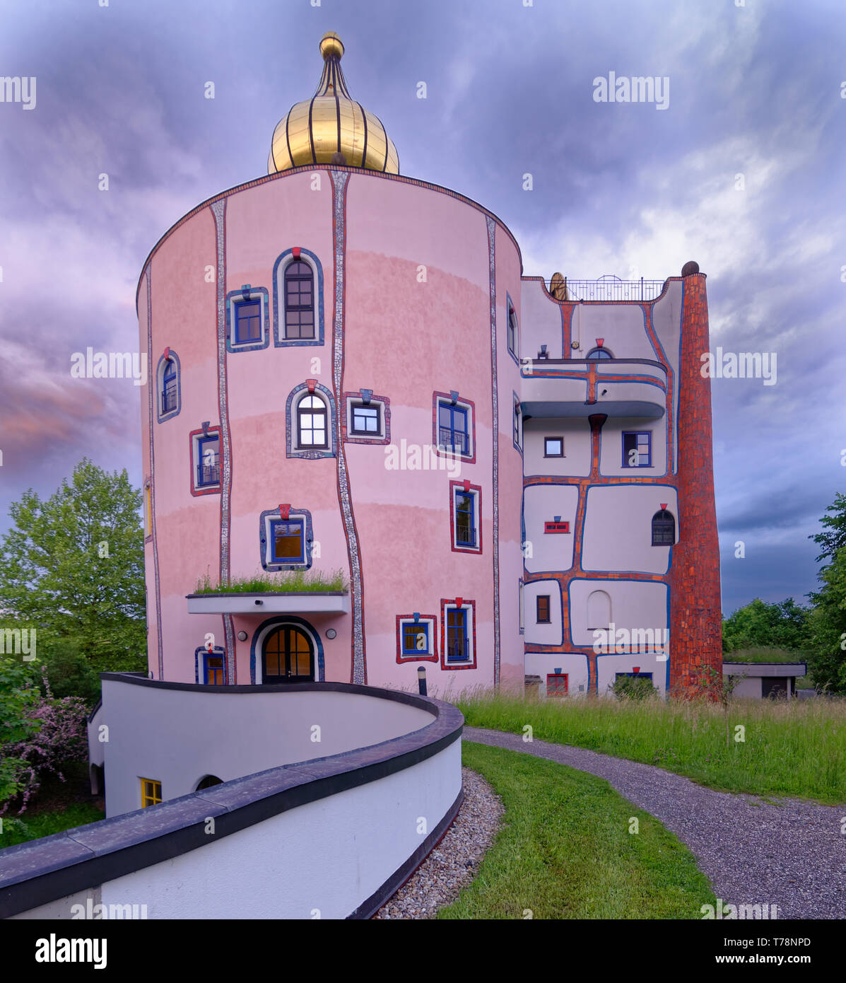 Looking up the path to the Stammhaus and its golden dome at Rogner Bad Blumau, Austria, a resort or spa hotel designed by Friedensreich Hundertwasser Stock Photo