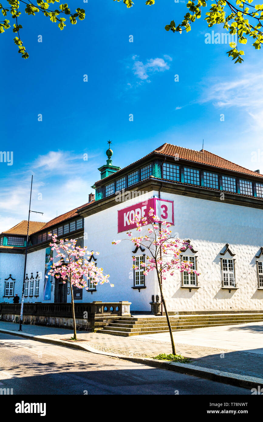 Kode 3 museum in Bergen, Norway in spring with cherry blossom tree in foreground Stock Photo