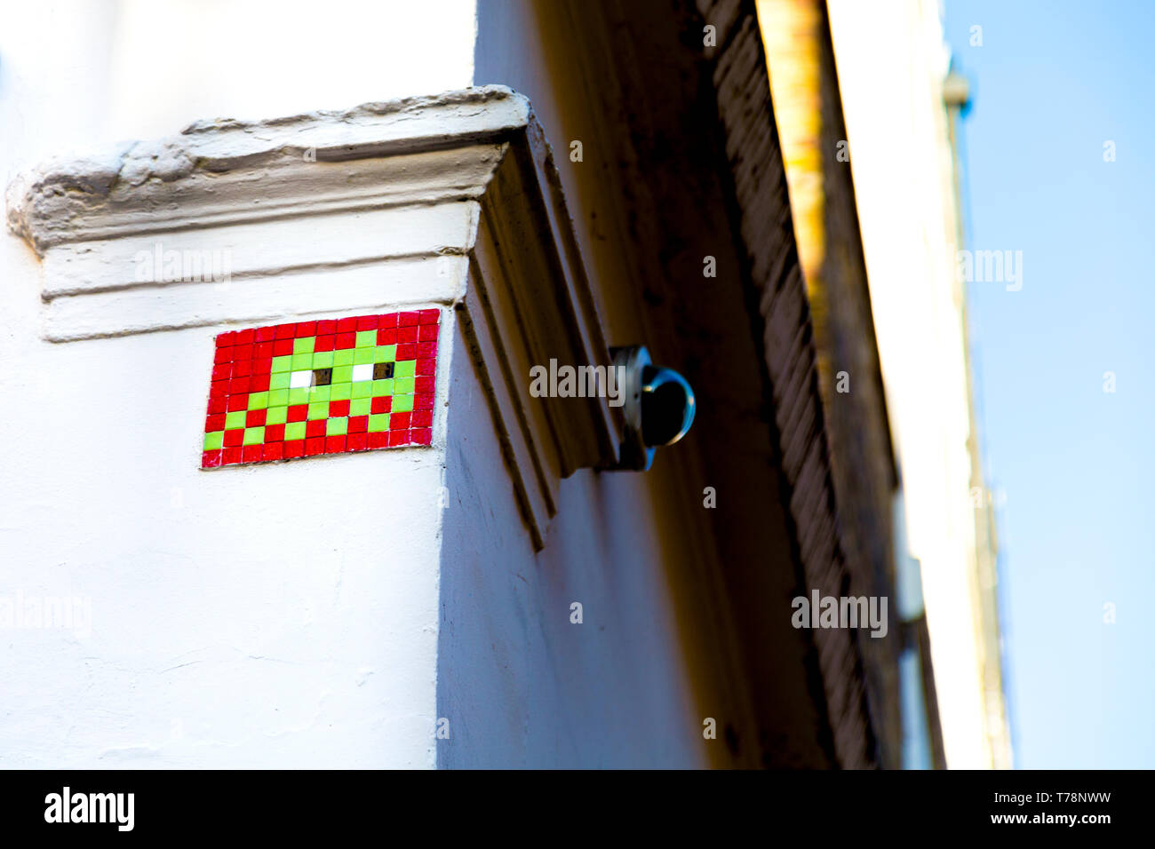 Mosaic on the wall of a building depicting a space invader by street artist Invader Stock Photo