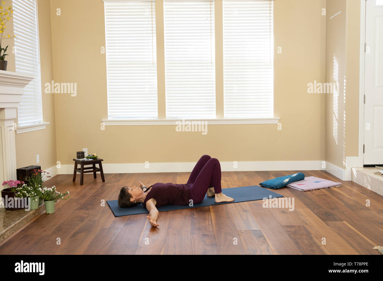 Yoga back on floor bent knees Stock Photo